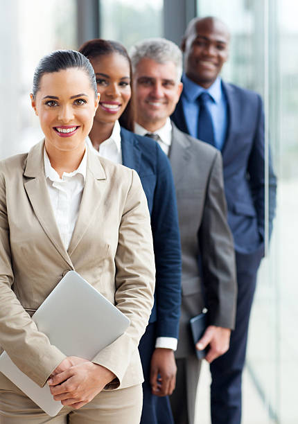 group of happy business executives standing in a row